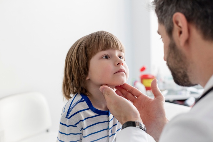 Doctor checking for symptoms of pediatric dysphagia in Houston, TX